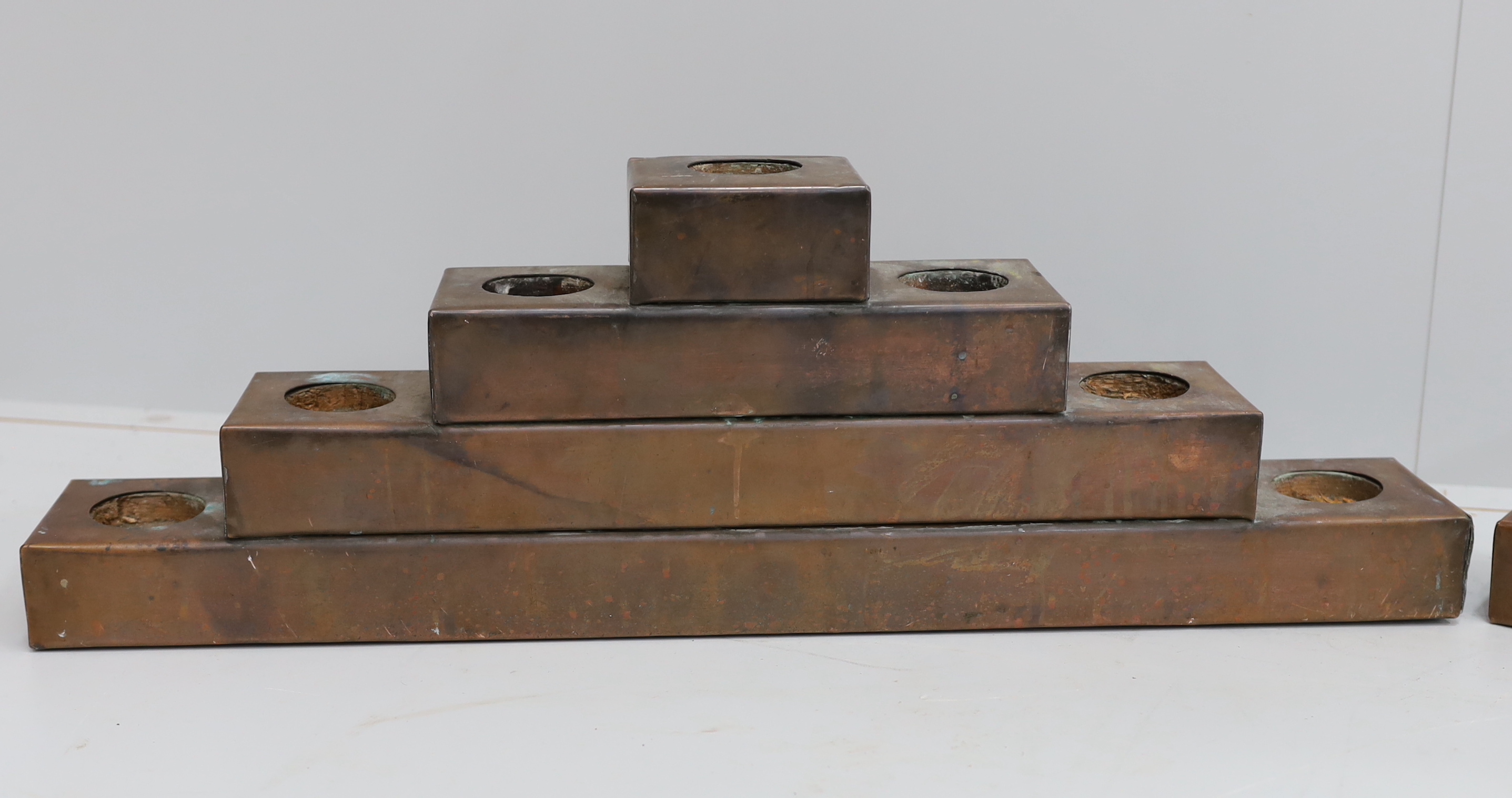 A pair of copper mounted candle holders, width 72cm, height 23cm